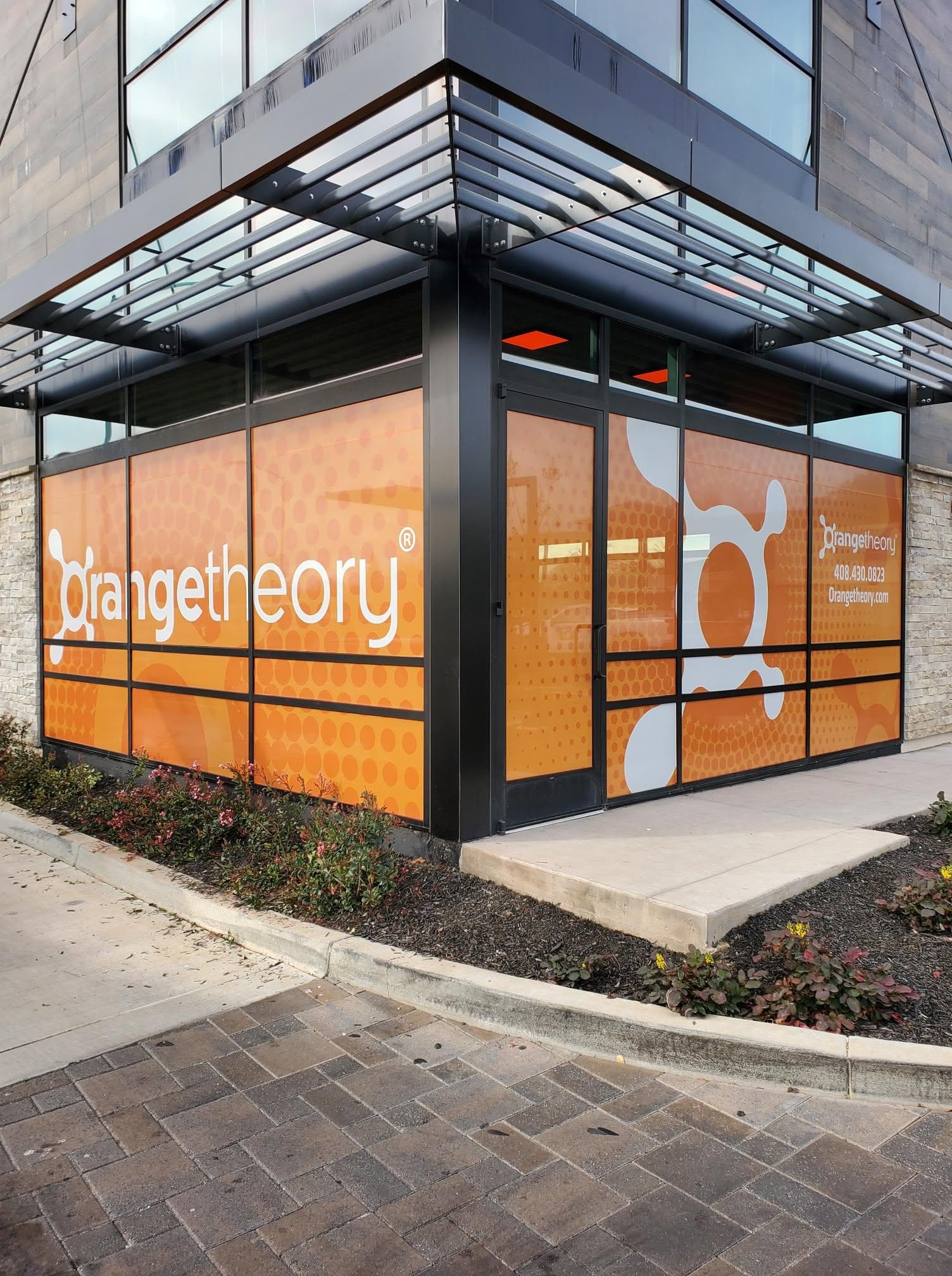 Completed Orangetheory Fitness perforated storefront window graphics